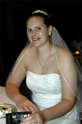 The bride takes a moment for some non-aggressive cake