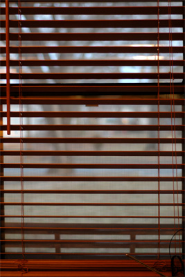 Looking through rose colored venetian blinds