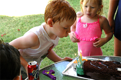 Lilly helps Harison blow out the candles