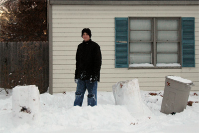 Davis stands in his unfinished snow fort